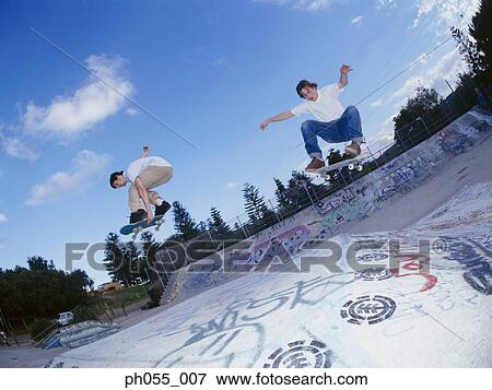 Two Young man skateboarding on ramp View Large Photo Image Stock Photo - Two Young man skateboarding on ramp . Fotosearch
