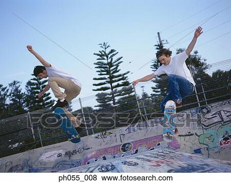 Two Young man skateboarding on ramp View Large Photo Image Stock Photo - Two Young man skateboarding on ramp . Fotosearch