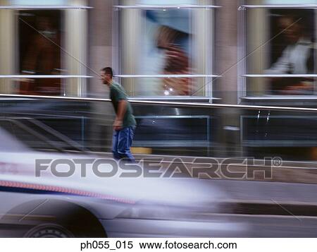 Young man skateboarding down the street View Large Photo Image Stock Photography - Young man skateboarding down the street. Fotosearch