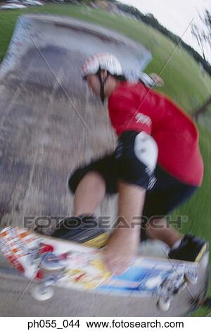 Picture - Young man skateboarding on ramp . Fotosearch