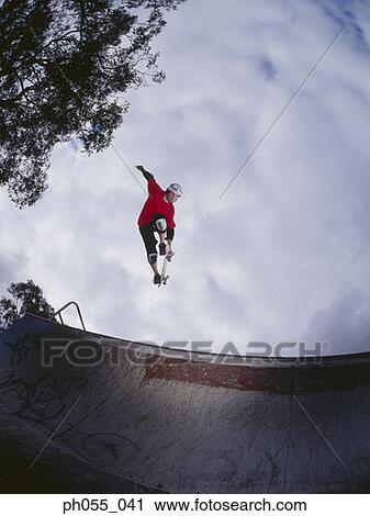 Young man skateboarding on ramp View Large Photo Image Stock Image - Young man skateboarding on ramp . Fotosearch
