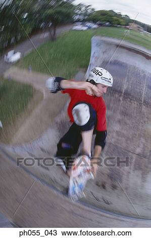 Young man skateboarding on ramp View Large Photo Image Stock Image - Young man skateboarding on ramp . Fotosearch