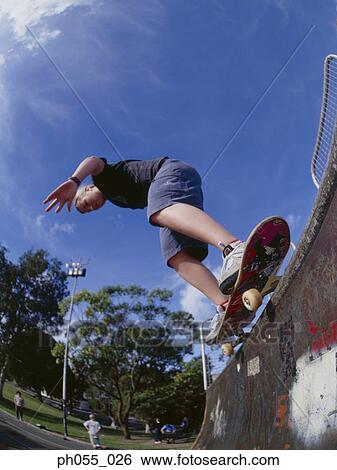 Stock Photograph - Young man skateboarding on ramp . Fotosearch
