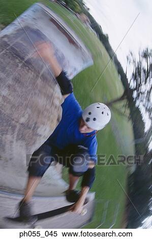 Stock Photography - Young man skateboarding on ramp . Fotosearch