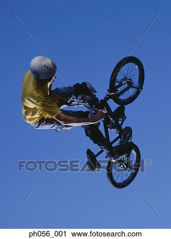 Male BMX stunt rider in mid-jump View Large Photo Image Stock Image - Male BMX stunt rider in mid-jump . Fotosearch