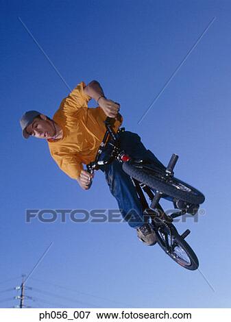 Male BMX stunt rider in mid-jump View Large Photo Image Stock Photo - Male BMX stunt rider in mid-jump . Fotosearch