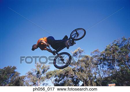 Male BMX stunt rider in mid-jump View Large Photo Image Stock Photo - Male BMX stunt rider in mid-jump . Fotosearch