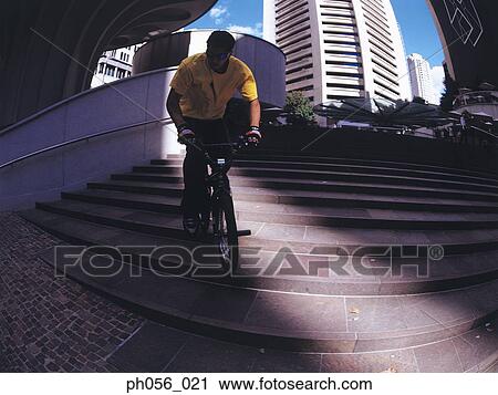 Young man riding BMX down stairs View Large Photo Image Stock Image - Young man riding BMX down stairs. Fotosearch