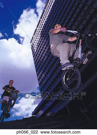Young men riding BMX down stairs View Large Photo Image Stock Image - Young men riding BMX down stairs. Fotosearch