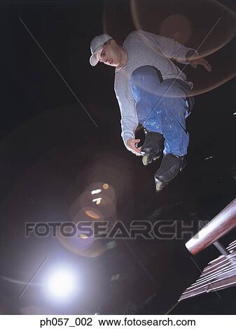 Stock Image - In-line skater in mid-jump . Fotosearch