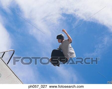 In-line skater in mid-jump View Large Photo Image Stock Photo - In-line skater in mid-jump . Fotosearch