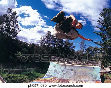 In-line skater performing stunt in mid-air View Large Photo Image Stock Image - In-line skater performing stunt in mid-air . Fotosearch