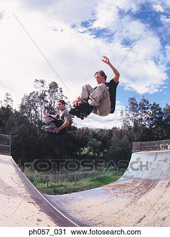 In-line skater performing stunt in mid-air View Large Photo Image Stock Image - In-line skater performing stunt in mid-air . Fotosearch