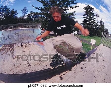 In-line skater performing stunt in mid-air View Large Photo Image Stock Image - In-line skater performing stunt in mid-air . Fotosearch