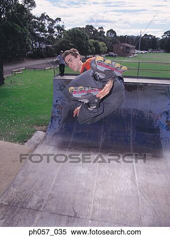 In-line skater performing stunt in mid-air View Large Photo Image Stock Photography - In-line skater performing stunt in mid-air . Fotosearch