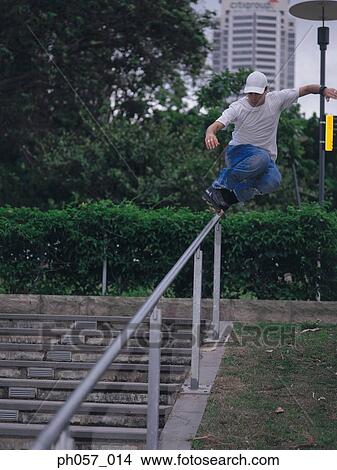 In-line skater performing stunt on railing View Large Photo Image Picture - In-line skater performing stunt on railing. Fotosearch