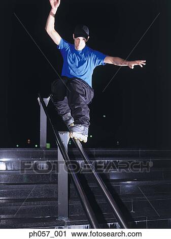 In-line skater performing stunt on railing View Large Photo Image Stock Image - In-line skater performing stunt on railing. Fotosearch