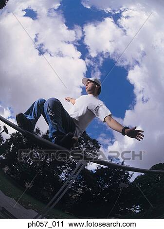 In-line skater performing stunt on railing View Large Photo Image Stock Image - In-line skater performing stunt on railing. Fotosearch