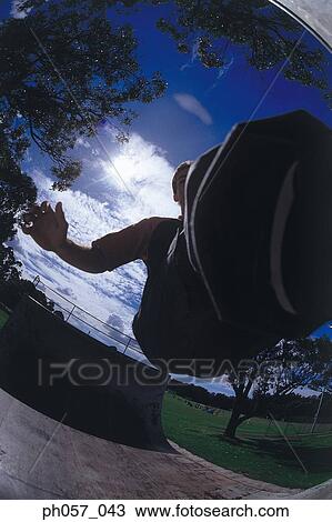 In-line skater performing stunt on ramp, mid-air View Large Photo Image Stock Image - In-line skater performing stunt on ramp, mid-air. Fotosearch