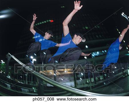 Stock Photo - In-line skater performing stunt on railing, multiple exposure. Fotosearch