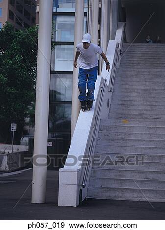 In-line skater performing stunt on railing View Large Photo Image Stock Photo - In-line skater performing stunt on railing. Fotosearch
