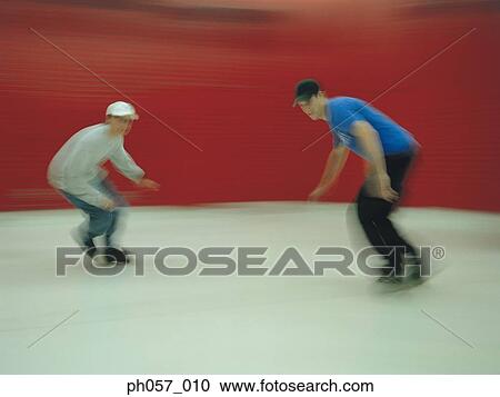 In-line skaters performing stunt in skating ring (blurred motion) View Large Photo Image Stock Image - In-line skaters performing stunt in skating ring (blurred motion) . Fotosearch