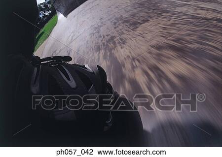 Stock Image - In-line skating on ramp, low-angle view (blurred motion) . Fotosearch
