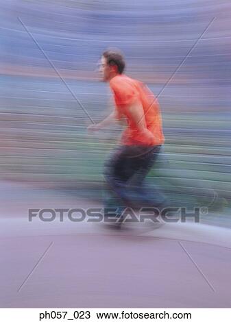 Young man inline skating on road (blurred motion) View Large Photo Image Stock Image - Young man inline skating on road (blurred motion) . Fotosearch