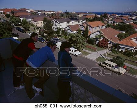 Friends looking down from a balcony View Large Photo Image Stock Image - Friends looking down from a balcony . Fotosearch