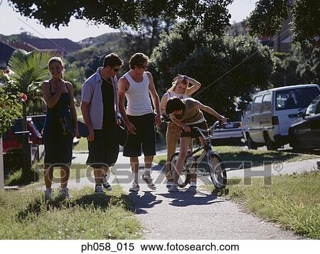 Stock Photography - Friends walking on sidewalk. Fotosearch