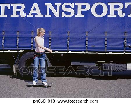 Young woman skateboarding beside a truck View Large Photo Image Stock Photo - Young woman skateboarding beside a truck. Fotosearch