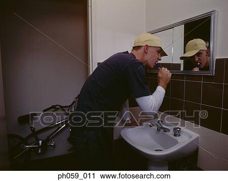 Young man brushing teeth View Large Photo Image Stock Image - Young man brushing teeth. Fotosearch