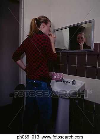 Young woman brushing teeth View Large Photo Image Stock Image - Young woman brushing teeth. Fotosearch