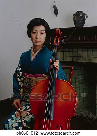 Stock Image - Japanese woman in kimono holding double bass . Fotosearch