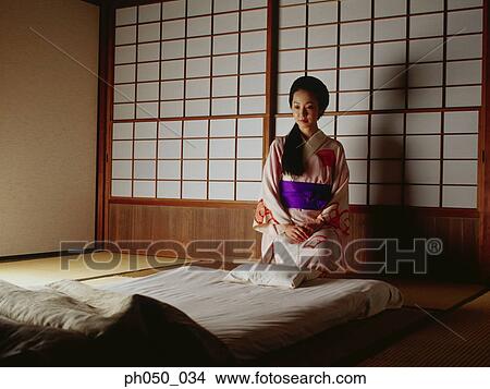 Japanese woman in kimono, sitting on bed View Large Photo Image Picture - Japanese woman in kimono, sitting on bed. Fotosearch