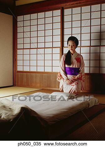 Japanese woman in kimono, sitting on bed View Large Photo Image Stock Photography - Japanese woman in kimono, sitting on bed. Fotosearch