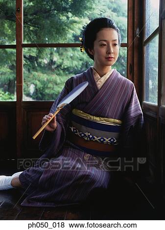 Stock Photo - Japanese woman in kimono, sitting on floor. Fotosearch