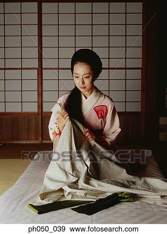 Japanese woman in kimono, sitting on mattress View Large Photo Image Stock Photo - Japanese woman in kimono, sitting on mattress. Fotosearch