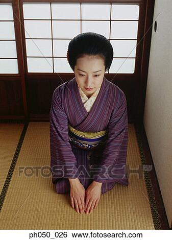 Stock Photograph - Japanese woman in kimono, sitting on floor. Fotosearch