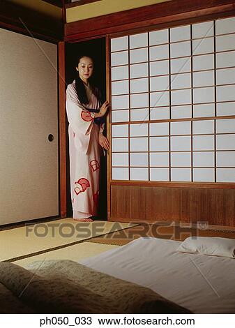 Japanese woman in kimono, standing by the door View Large Photo Image Stock Image - Japanese woman in kimono, standing by the door. Fotosearch