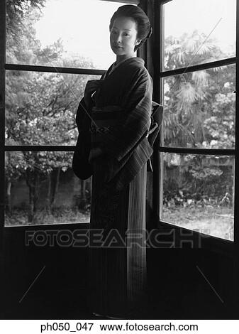 Japanese woman in kimono, standing by the window View Large Photo Image Stock Photo - Japanese woman in kimono, standing by the window. Fotosearch