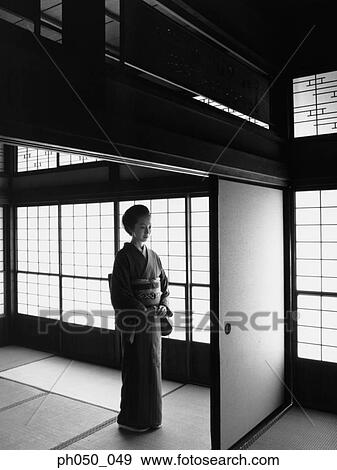 Japanese woman in kimono, standing by the door View Large Photo Image Stock Photo - Japanese woman in kimono, standing by the door. Fotosearch