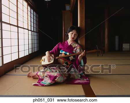 A young woman in kimono plays 'samisen' View Large Photo Image Stock Image - A young woman in kimono plays 'samisen'. Fotosearch