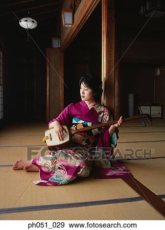 A young woman in kimono plays 'samisen' View Large Photo Image Stock Photo - A young woman in kimono plays 'samisen'. Fotosearch