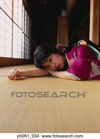 Close-up portrait of a woman in kimono lying on floor View Large Photo Image Picture - Close-up portrait of a woman in kimono lying on floor . Fotosearch
