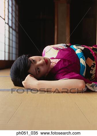 Close-up portrait of a woman in kimono lying on floor View Large Photo Image Stock Photography - Close-up portrait of a woman in kimono lying on floor . Fotosearch