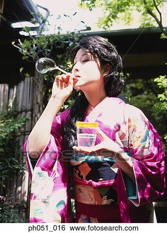 Japanese woman in kimono blowing bubbles View Large Photo Image Stock Photograph - Japanese woman in kimono blowing bubbles. Fotosearch