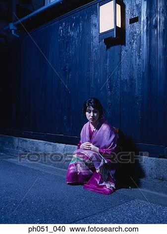 Japanese woman in kimono crouching against wall View Large Photo Image Stock Image - Japanese woman in kimono crouching against wall. Fotosearch