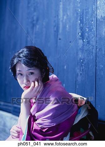 Japanese woman in kimono crouching against wall View Large Photo Image Stock Image - Japanese woman in kimono crouching against wall. Fotosearch