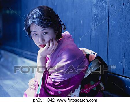 Japanese woman in kimono crouching against wall View Large Photo Image Stock Image - Japanese woman in kimono crouching against wall. Fotosearch
